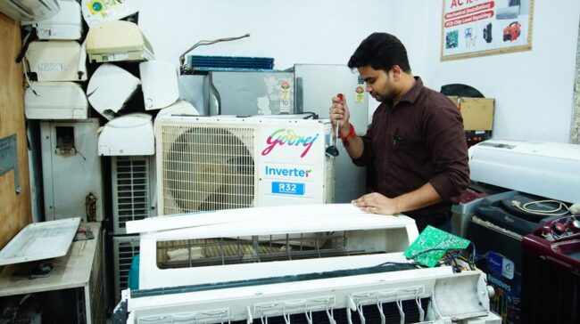 Technician repairing an air conditioner unit in New Delhi workshop. - Photo by Multitech Institute on Pexels