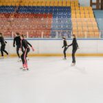 Five young skaters practice figure skating on an indoor ice rink, focusing on teamwork and technique. - Photo by Pavel Danilyuk on Pexels