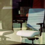 Contemporary office chairs displayed behind glass, offering modern ergonomic solutions for workspace. - Photo by aboodi vesakaran on Pexels